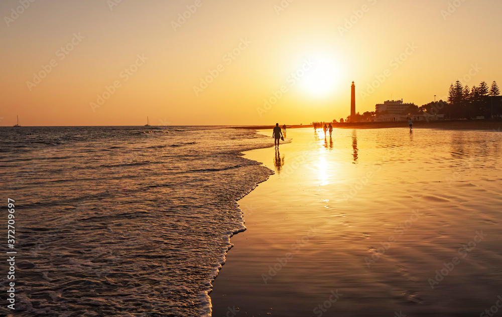 sunset at the beach, lighthouse maspalomas gran canaria