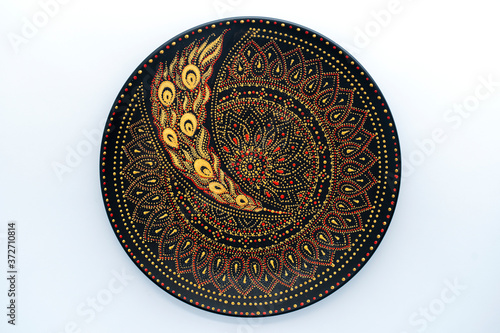 Decorative ceramic plate with black, red and golden colors, painted plate on white background , dot painting © OlegD