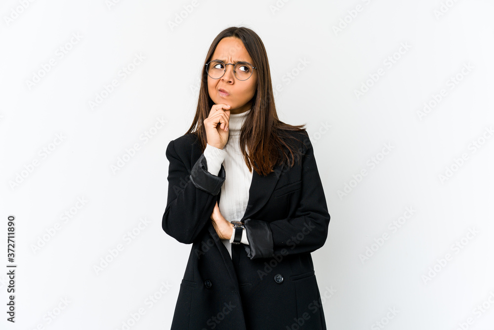 Young mixed race business woman isolated on white background looking sideways with doubtful and skeptical expression. Young mixed race business woman isolated on white background looking sideways with doubtful and skeptical expression.