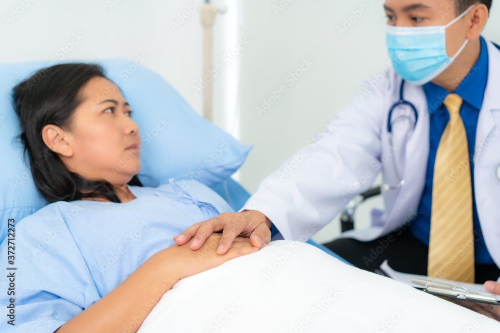 Obraz premium Close up of man doctor touching patient hand for encouragement and empathy on the hospital, cheering and support patient, Bad news, medical examination, trust and ethics..