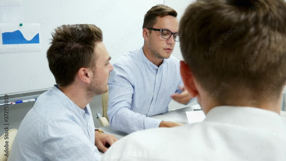 Collective of office workers discuss a project, businessmen working with documents, graphs, diagrams and laptop in close-up Collective of office workers discuss a project, businessmen working with documents, graphs, diagrams and laptop in close-up