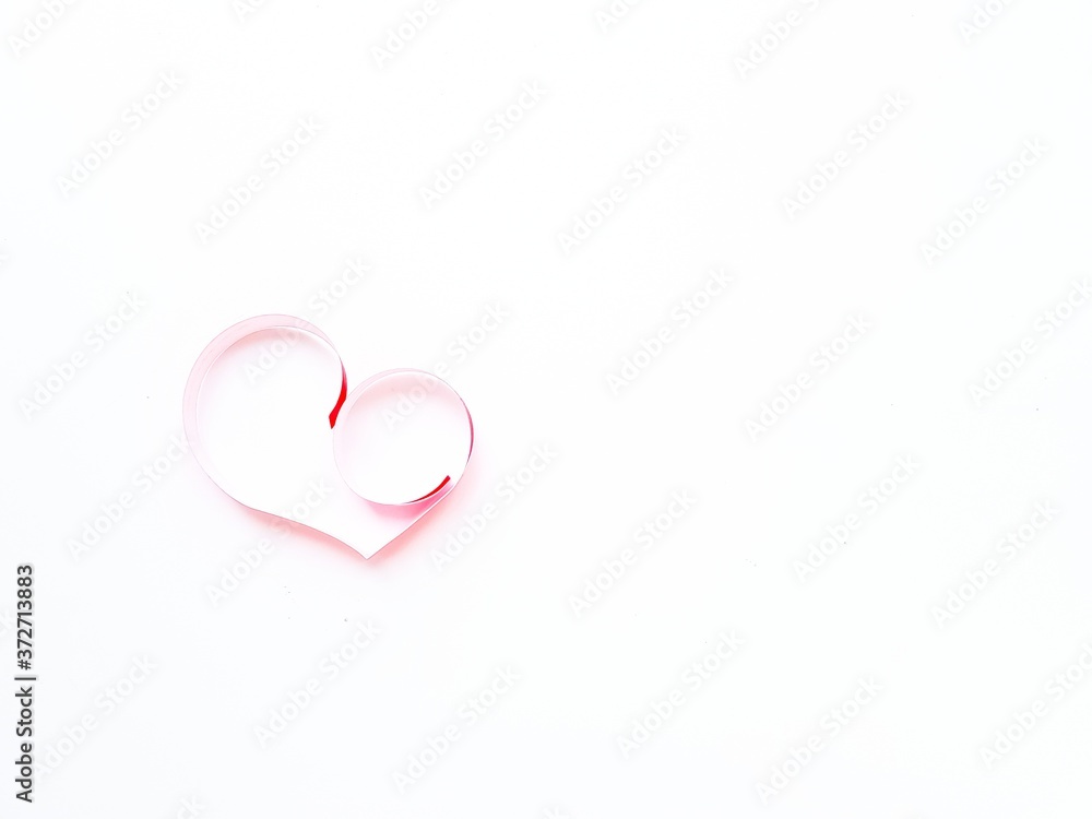 The heart is made of red paper on a white background. Valentine's Day.