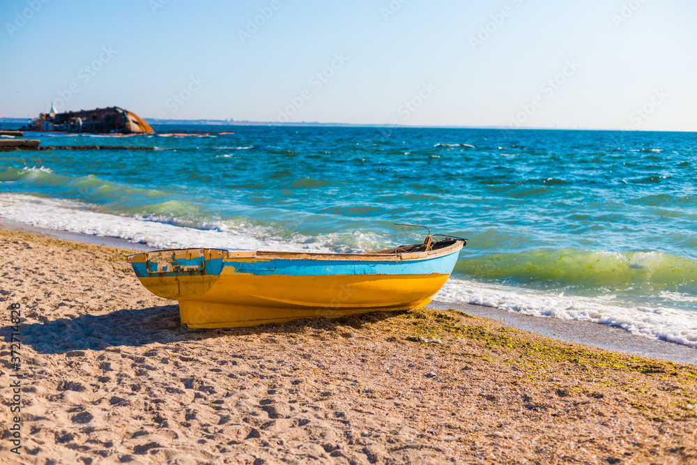 Beautiful seascape view with an old boat on the blue sea tropical beach in sunny day Beautiful seascape view with an old boat on the blue sea tropical beach in sunny day