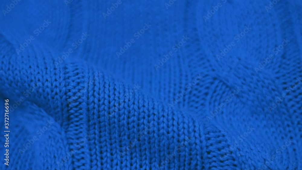 Close-up of the Blue Knitted Fabric Texture. Cozy and Soft Cotton Plaid, Textiles, Clothing. Textile Factory. Garment Industry. Close-up of the Blue Knitted Fabric Texture. Cozy and Soft Cotton Plaid, Textiles, Clothing. Textile Factory. Garment Industry.