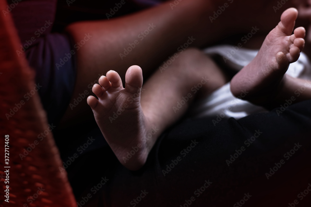 In selective focus of Newborn baby foot,blurry light around In selective focus of Newborn baby foot,blurry light around