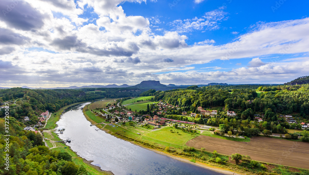 View from the bastei viewpoint of the Elbe river and the Rathen town in beautiful landscape scenery, Sandstone mountains, Saxon Switzerland National Park, Germany