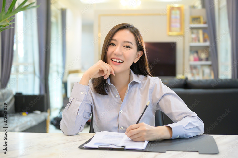 Headshot screen view of young Asian businesswoman is online using Video conference with partners or business coworkers from her home . Headshot screen view of young Asian businesswoman is online using Video conference with partners or business coworkers from her home .