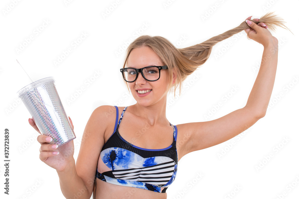 Portrait of a blonde girl in a blue swimsuit holding a glass of lemonade. Summer holidays Portrait of a blonde girl in a blue swimsuit holding a glass of lemonade. Summer holidays
