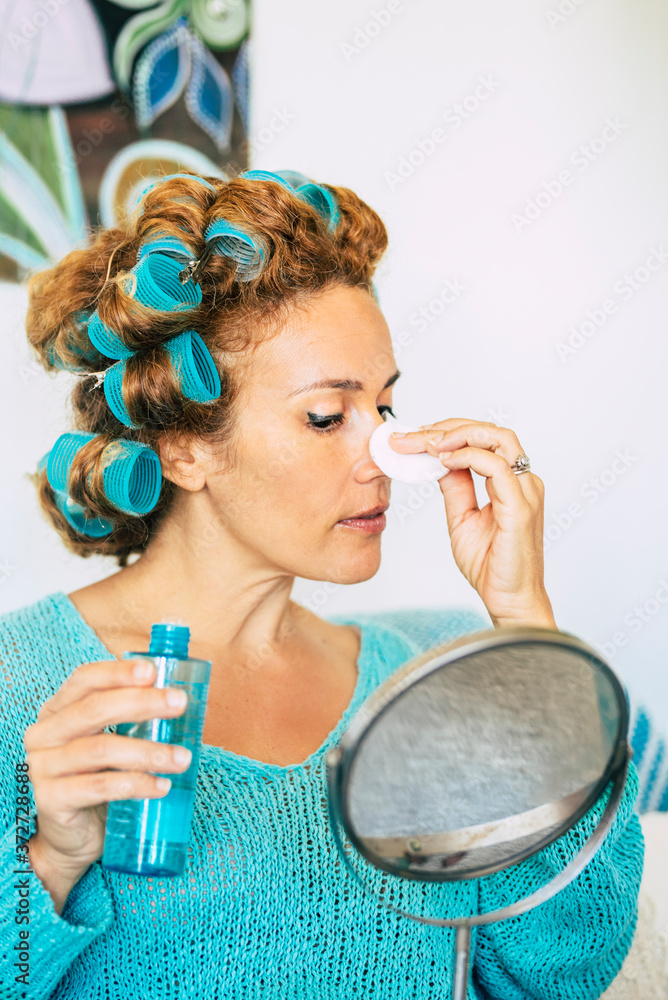Φωτογραφία Beautiful adult woman getting ready and make up cleaning the face at home with c
