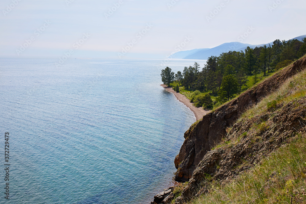 Obraz premium View above big beautiful lake, Baikal lake, Russia. Sunny summer evening