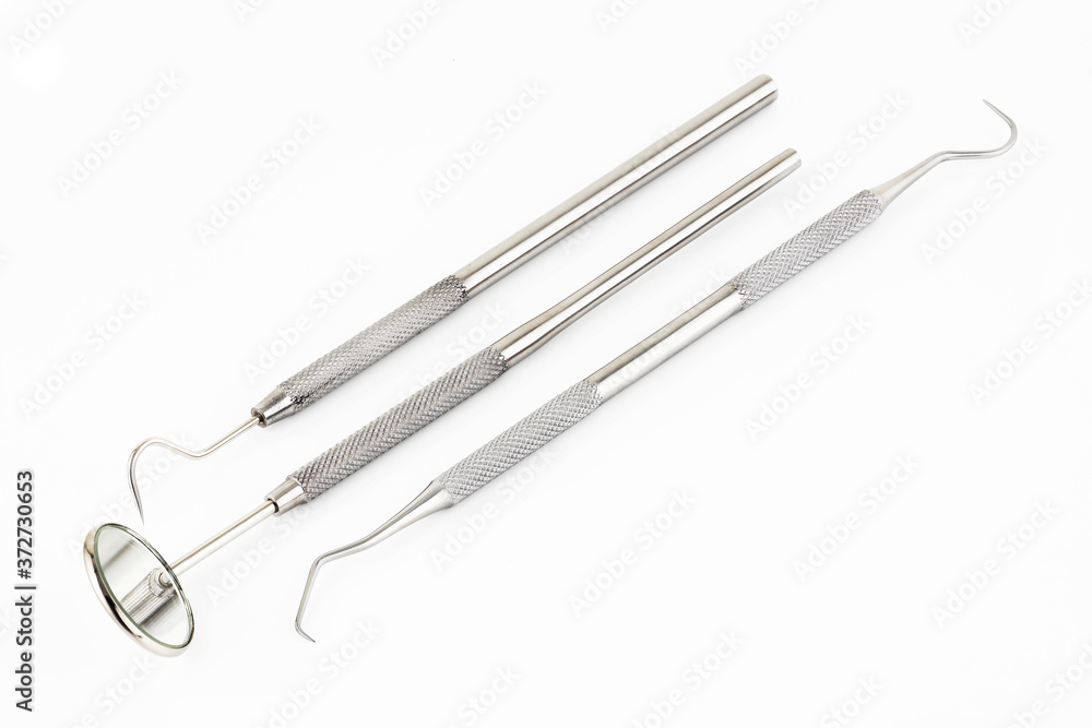 Dental mirror scaler and sickle probe explorer tools on white background