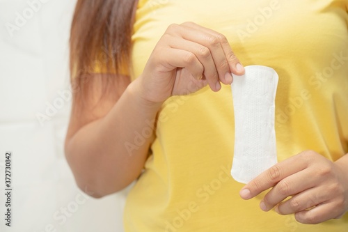 Women carry a sanitary napkin to use to cure vaginal discharge. photo