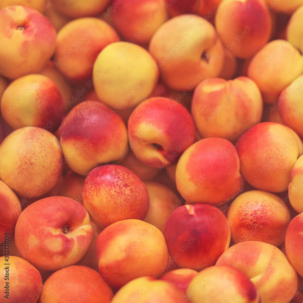 Tender ripe fragrant nectarines are lying in the grocery store, ready to buy. Background of fruit. Good harvest. Tender ripe fragrant nectarines are lying in the grocery store, ready to buy. Background of fruit. Good harvest.