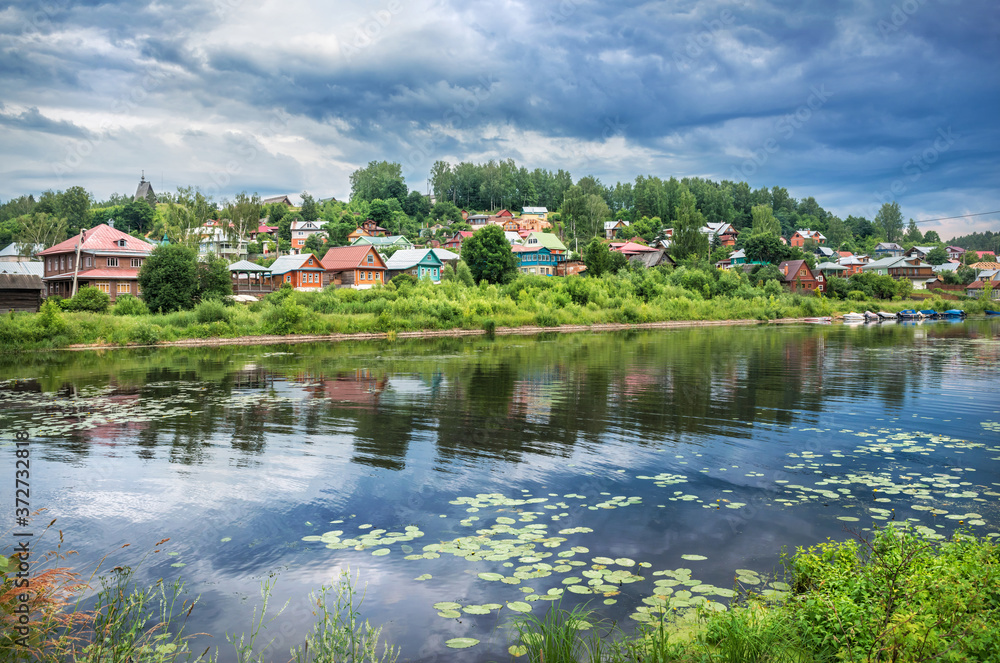 Old wooden houses on the banks of the Shokhonka river in  Plyos