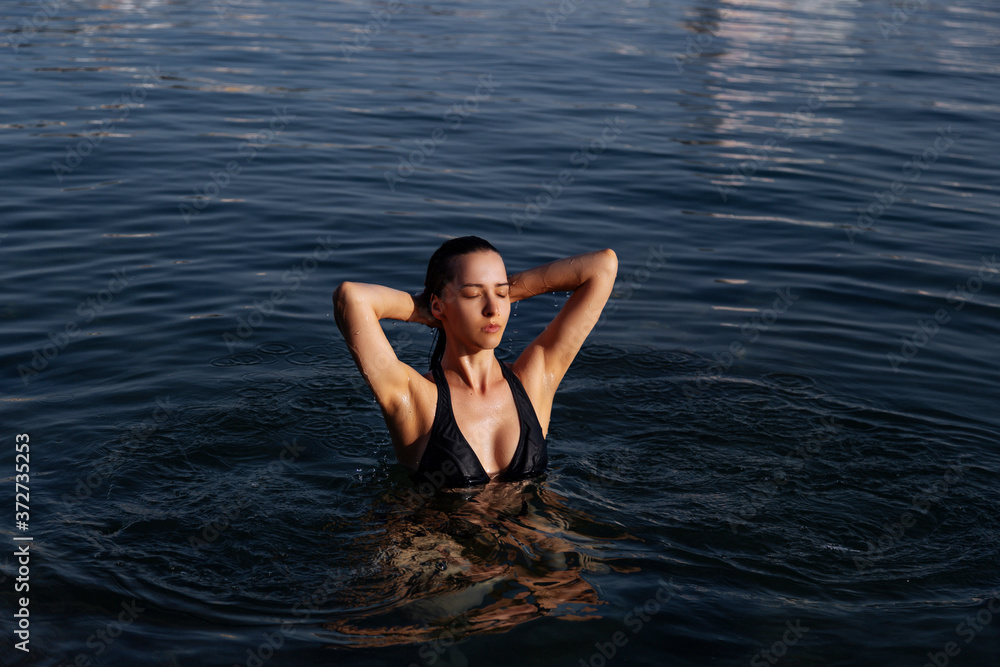 Young woman resting alone. Picture of calm relaxed girl in water swimming.Enjoy summer vacation 2020.Girl, model in the sea. The image of life, style, fashion, beauty. Young woman resting alone. Picture of calm relaxed girl in water swimming.Enjoy summer vacation 2020.Girl, model in the sea. The image of life, style, fashion, beauty.