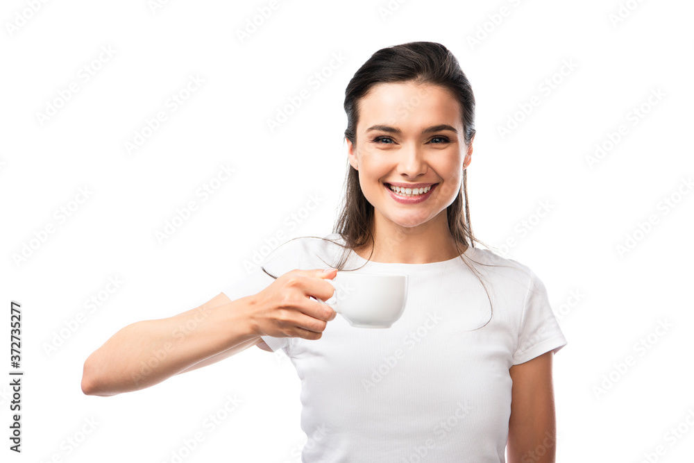 brunette woman in white t-shirt looking at camera and holding cup with coffee isolated on white brunette woman in white t-shirt looking at camera and holding cup with coffee isolated on white