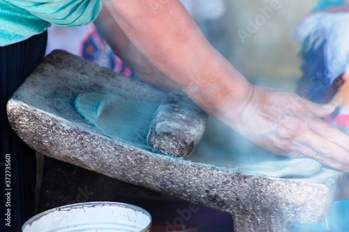 Obraz na płótnie Hands of indigenous women making blue corn dough in a traditional way w salonie