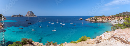 Panorama of Cala Hort with sea sailing yachts and the mountain Es Vedra. Ibiza, Balearic Islands, Spain
