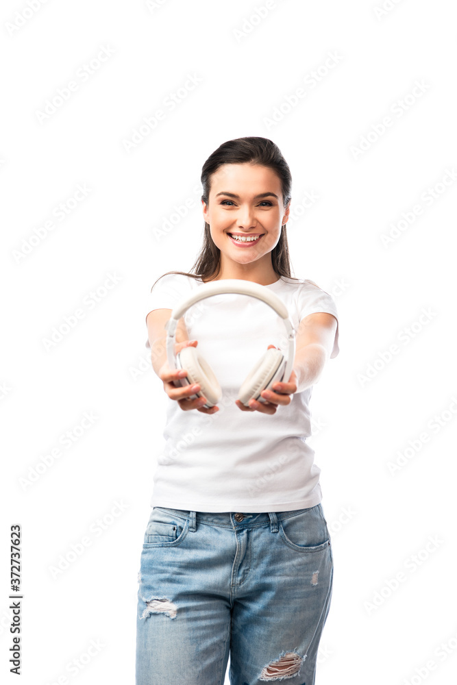 selective focus of young woman in white t-shirt holding wireless headphones isolated on white selective focus of young woman in white t-shirt holding wireless headphones isolated on white
