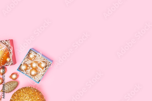 golden christmas decoration on pastel pink background, copy space, layout