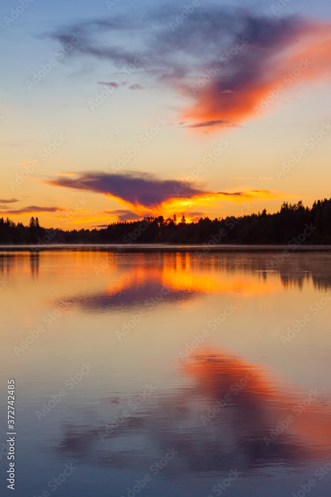 Sunset on the lake, Valday, Russia. Bright orange landscape