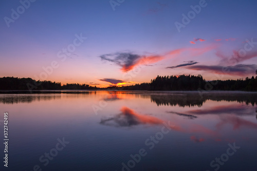 The sunset on the lake, Valday, base of rest "Vatsy", Russia. Lilac landscape