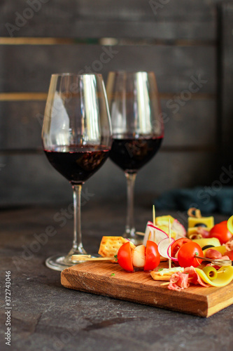 glass of wine and a snack canapes cheese plate serving size natural product portion top view place for text copy space