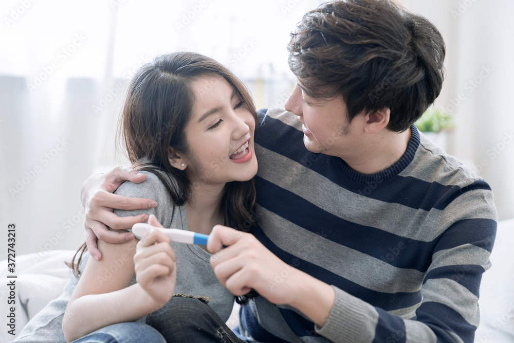 Happy Asian Couple, They were glad to see the results of the pregnancy test, They are going to have children. Happy Asian Couple, They were glad to see the results of the pregnancy test, They are going to have children.