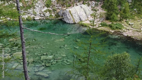 Italy  Piedmont,  Devero village  , ( lago delle streghe )  Alps - caucasian girl do trekking , hiking in a wood mountains, 
Lake of witches  with clear water in a wild landscape of nature