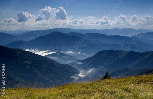 Summer day in the mountains under a bottomless sky with clouds