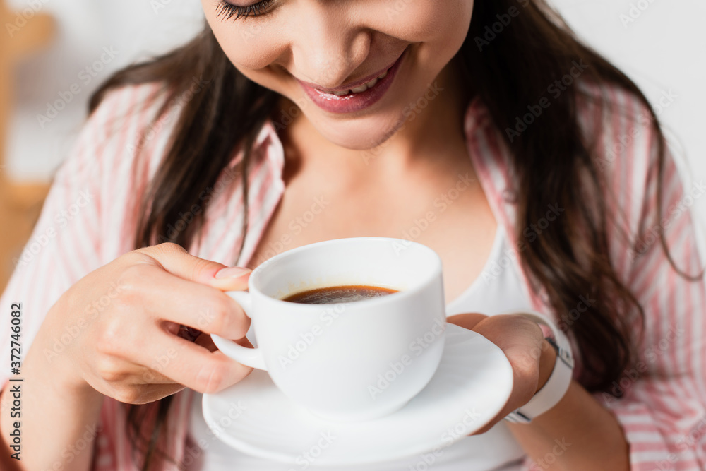 cropped view of young woman holding cup of coffee cropped view of young woman holding cup of coffee