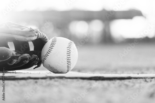 Photography baseball and glove on sports field with blurred background in black and white