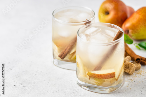 Sparkling pear cinnamon cocktail in glasses. Space for text.