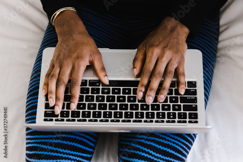 Overhead view of woman's hands on laptop keyboard photo