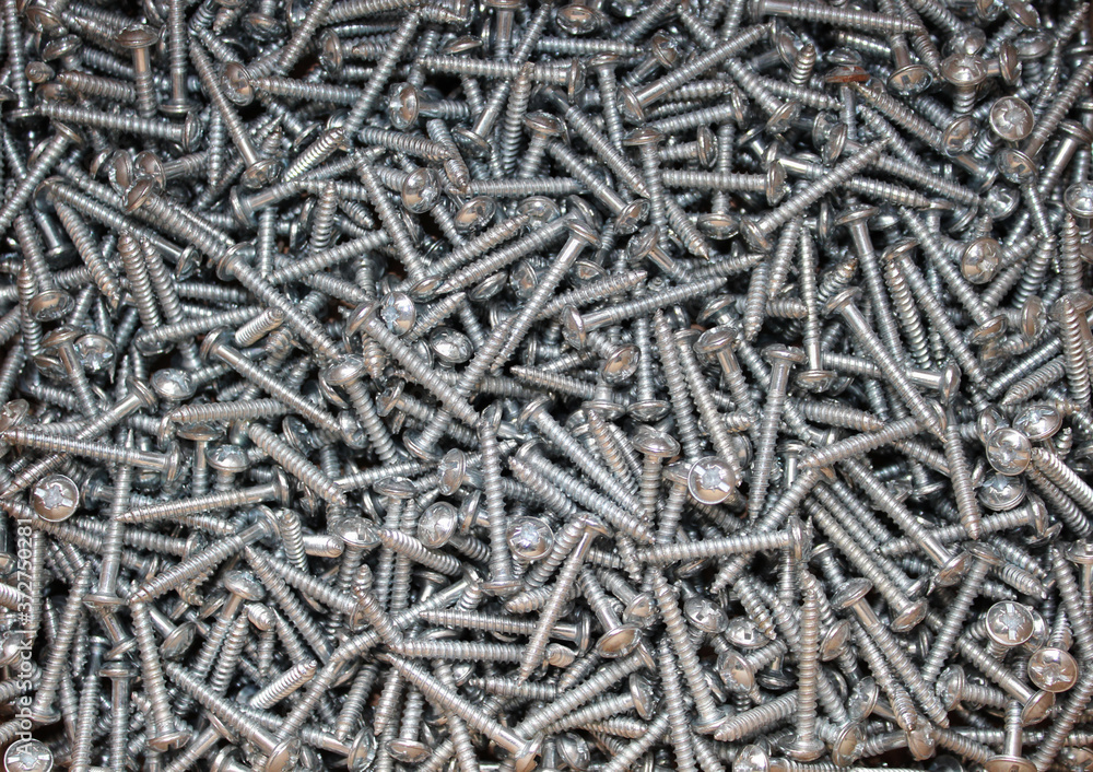 Macro photo of set of screws. Construction abstraction. Industrial background. Screw background, steel screw. Macro photo of set of screws. Construction abstraction. Industrial background. Screw background, steel screw.