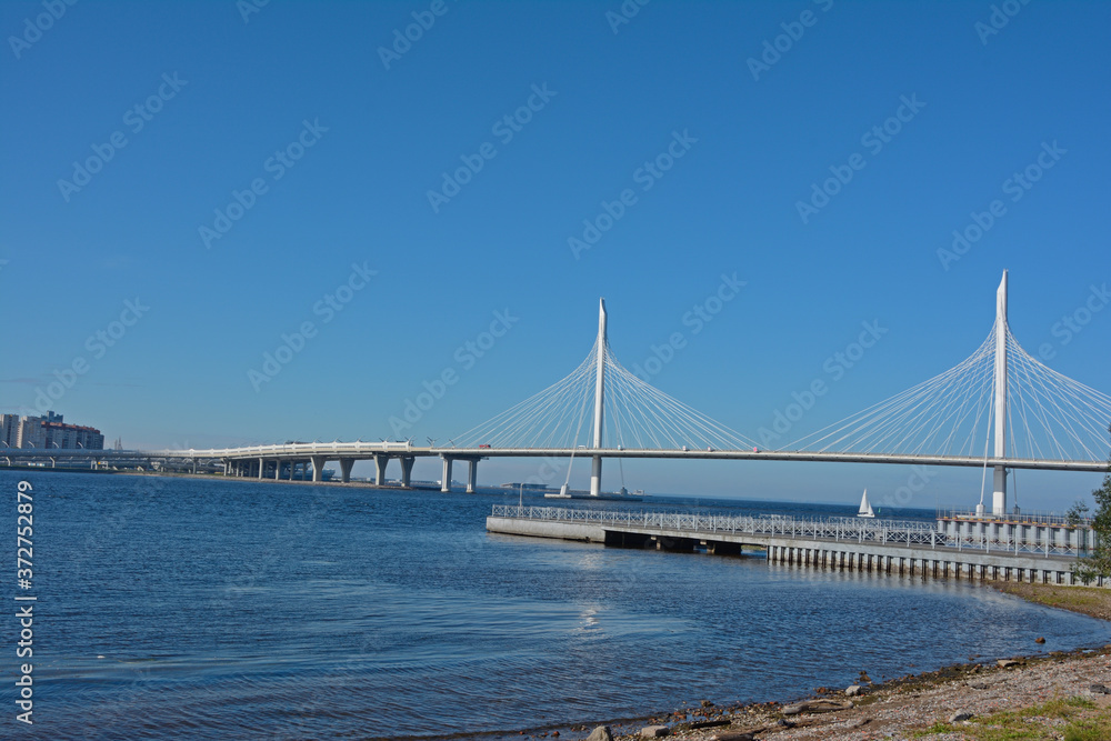 Vansu bridge. Across a large river against a bright, clear, blue sky