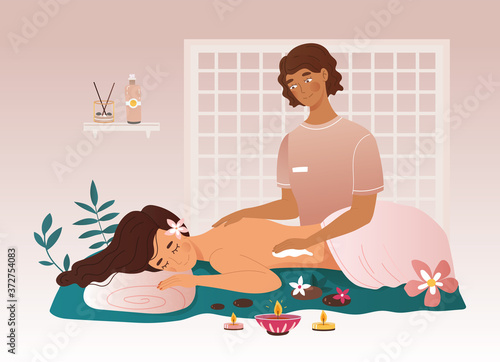 Woman having a massage treatment in a spa centre with a female masseuse surrounded with fresh flowers and a burning candle, colored vector illustration