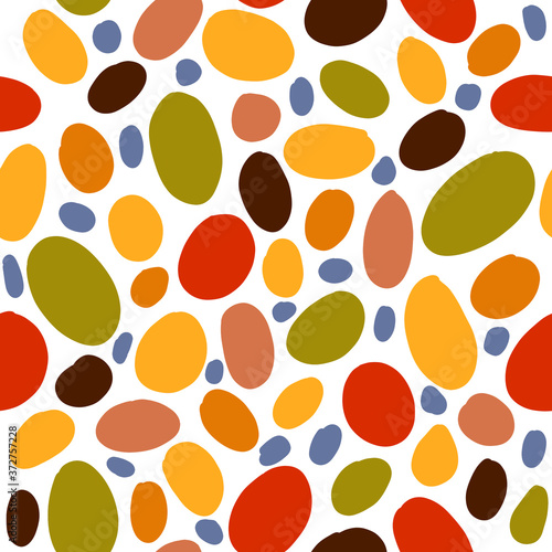 Seamless pattern of multicolored bright ovals of different sizes: green, orange, blue, and maroon.