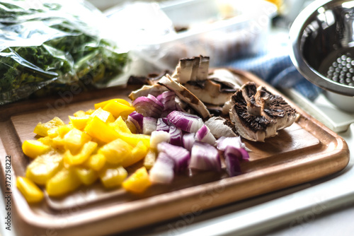Mushroom, red onions and yellow pepper prepared for a vegetable stir fry 