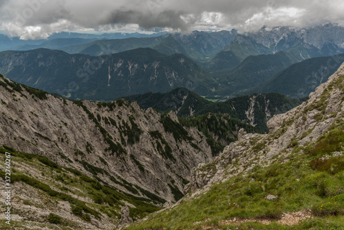 View to Slovenia from path to Mittagskogel hill in cloudy summer day