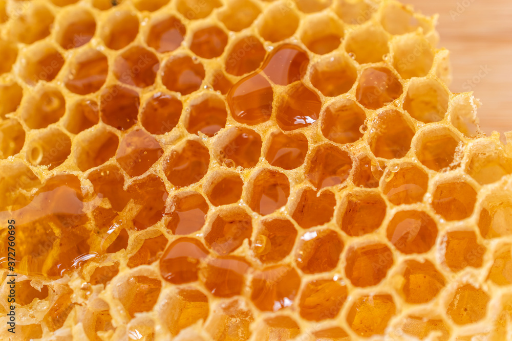 Close up of golden color natural honeycomb full of fresh honey. Close up of golden color natural honeycomb full of fresh honey.