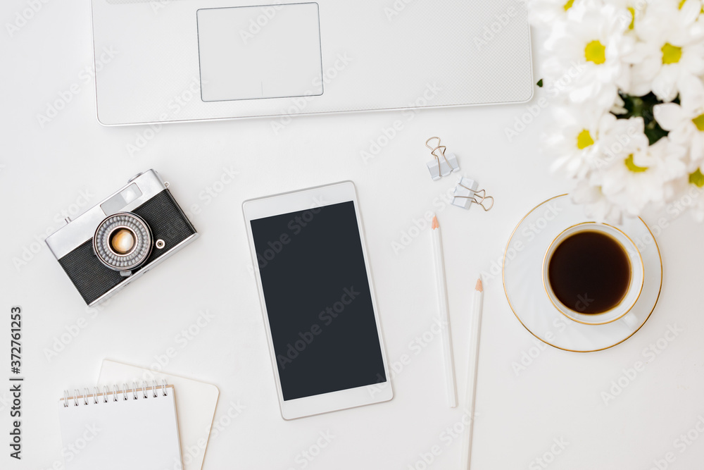 Flat lay mockup smartphone blank screen, laptop a cup of coffee on a white background Flat lay mockup smartphone blank screen, laptop a cup of coffee on a white background
