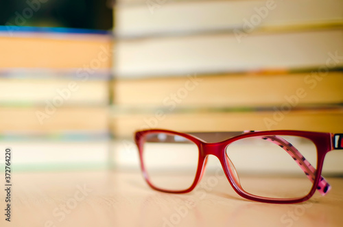 soft magic glasses, blur books stack on wooden table