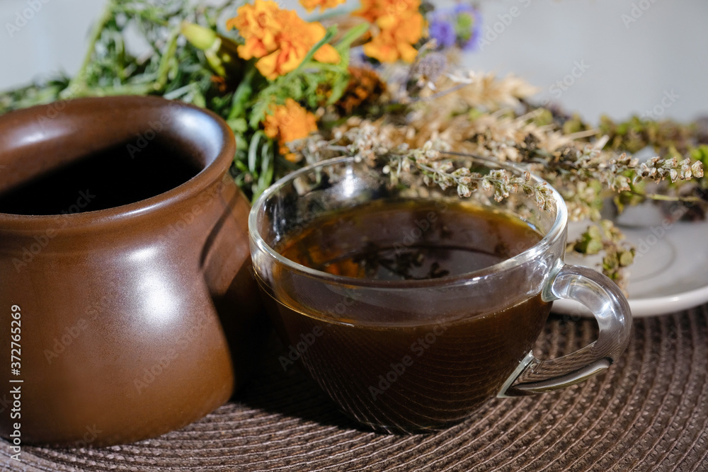 A cup of hot coffee on the kitchen table. Strong invigorating drink close-up. A cup of hot coffee on the kitchen table. Strong invigorating drink close-up.
