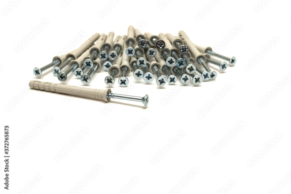 Dowel nail for attaching to dense materials as bricks, stone, concrete