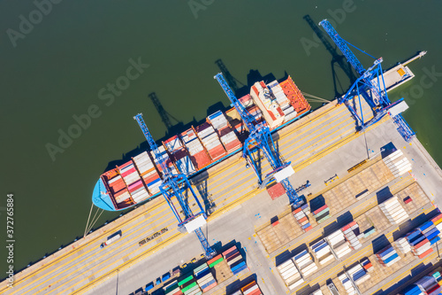 Aerial top view container cargo ship, in import export business logistic and transportation by container ship international open sea.