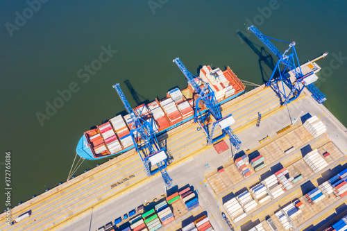 Aerial top view container cargo ship, in import export business logistic and transportation by container ship international open sea.