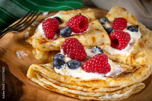 Pancakes with white cheese and fruit.