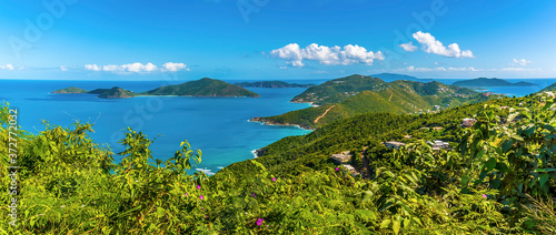 A view past lush vegetation towards the islands of Guana, Great Camanoe and Scrub from the main island of Tortola photo