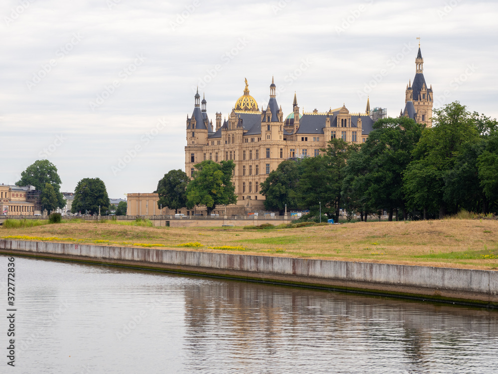 Schwerin castle in summer with overcast sky and calm water